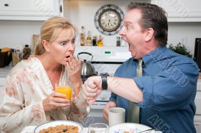 Stressed Couple in Kitchen Late for Work