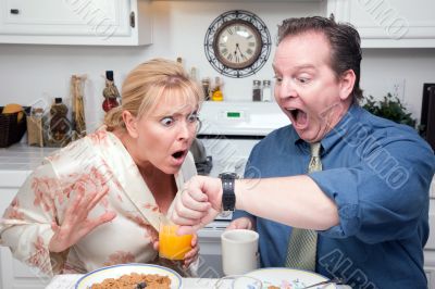 Stressed Couple in Kitchen Late for Work