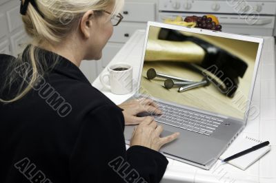 Woman In Kitchen Using Laptop - Home Improvement