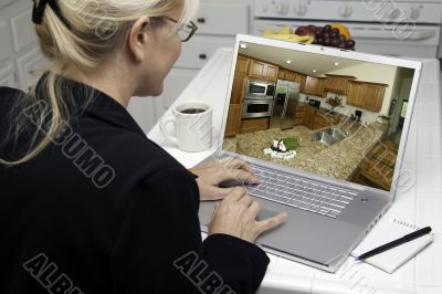 Woman In Kitchen Using Laptop - Home Improvement