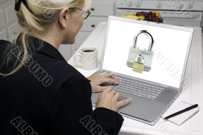 Woman In Kitchen Using Laptop - Security