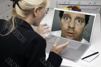 Excited Woman In Kitchen Using Laptop - Intrusion of Privacy