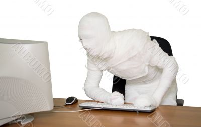 Bandaged businessman on workplace in office