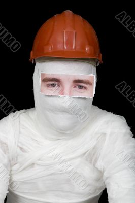 Bandaged man in helmet with false paper eyes
