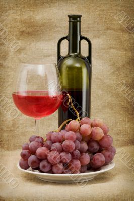 Green bottle, goblet and grapes