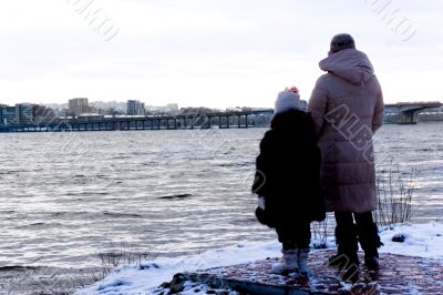 mother and daughter look at the river mother and daughter look at the river