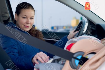 Mother and child in car safety seat