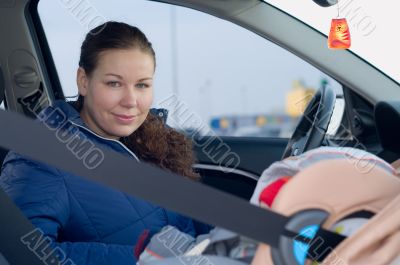 Mother and child in safety seat