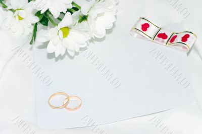 wedding rings with white flowers.
