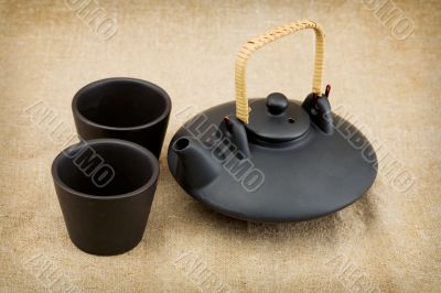 Black ceramic chinese teapot and mugs