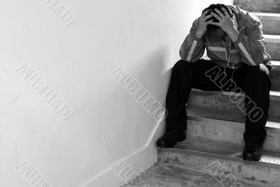Frustrated man sitting on steps Frustrated man sitting on steps