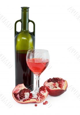 Glass of wine, bottle and a red pomegranate