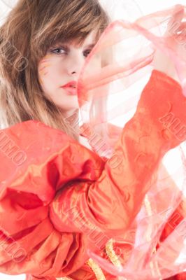 Cute teenage girl showing her orange fancy dress