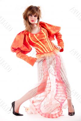 Cute teenage girl in an orange fancy dress posing