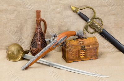 Bottle, rapier, sword, pistol and chest