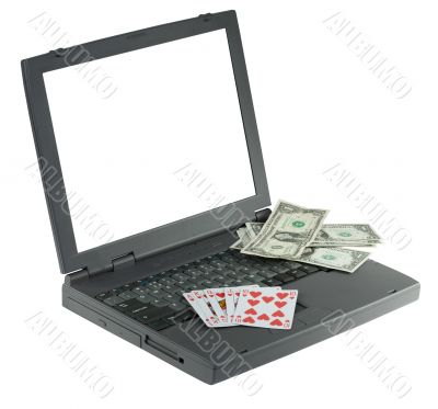 Laptop with playing card and money