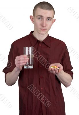 Guy with glass of water and tablets