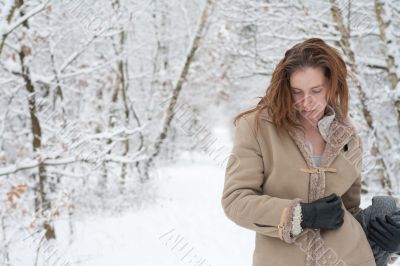 Winter landscape woman standing pensive in the snow Winter landscape woman standing pensive in the snow