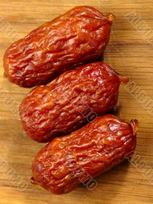 Bavarian smoked sausage on wood background