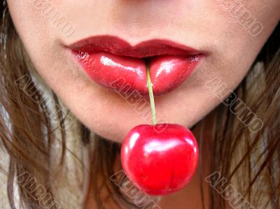 Red cherry in red lips