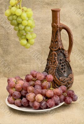 Ceramic bottle and grapes