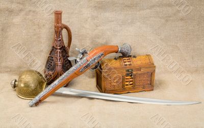 Bottle, rapier, sword, pistol and chest