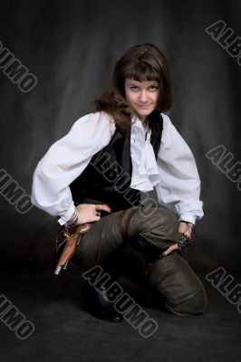 Girl - pirate with pistol sit on black
