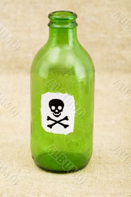 Green bottle with sticker skull and crossbones
