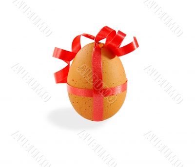 Egg with pink ribbon on white with clipping path.