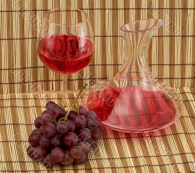 Stil life with decanter, goblet and grape