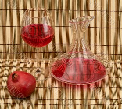 Stil life with decanter, goblet and pomegranate