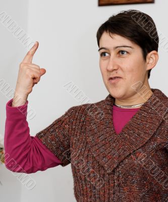Short-haired woman raising her finger