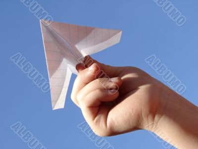 child hand with paper plane