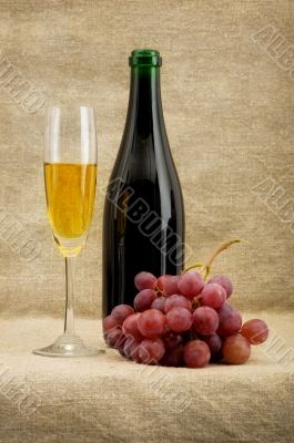 Champagne bottle, goblet, grapes