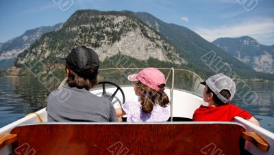 Mother with 2 kids in a motor boat