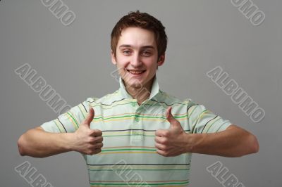smiling young man with thumbs up