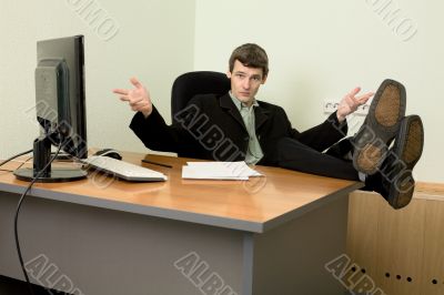 Boss in black suit on a workplace