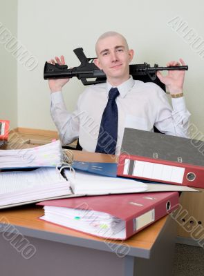 Self-satisfied worker of office armed with a rifle
