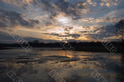 Magnificent sunset on frozen lakes edge