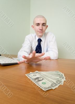 Man reaches for a batch of money