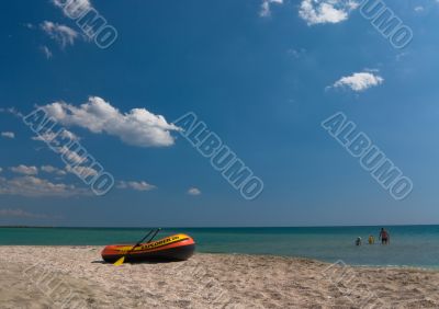 Seashore with an inflatable boat and sea