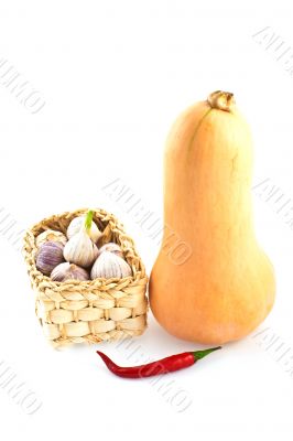 basket of garlic, paprika and a pumpkin