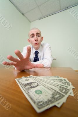 Man reaches for a batch of money