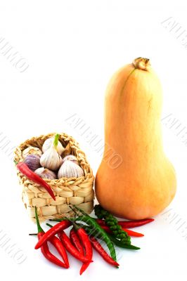 basket of garlic with paprika and a pumpkin