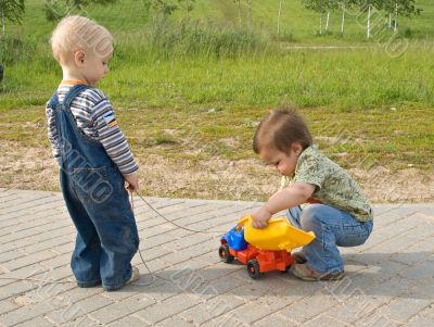 Children with a toy truck