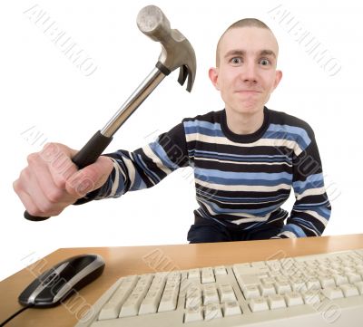 Young man with hammer on hand and keyboard
