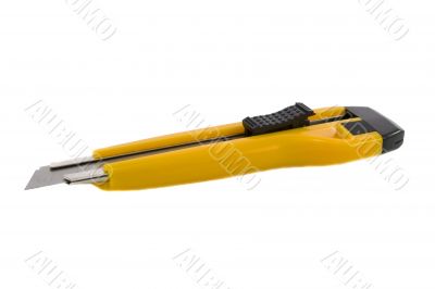 Yellow office knife with push blade isolated over white backgrou