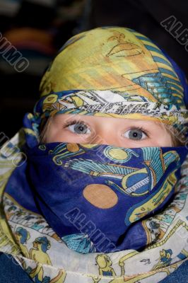 Curious child dressed in Arabian headscarf