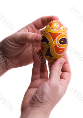 Colorful Easter egg in  hands, isolated.