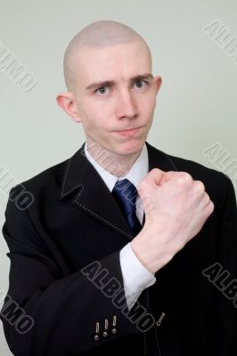 Man in a suit threatens with a fist